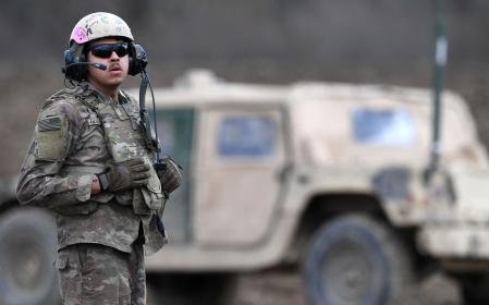 (FILES) An US soldier stands in front of a military vehicle in the trainings area of the 'Dynamic Front 23, the US Army led NATO and Partner integrated annual artillery exercise in Europe, in Grafenwoehr, near Eschenbach, southern Germany, on March 28, 2023. Two German-Russian nationals have been arrested in Bavaria on suspicion of spying for Russia and planning acts of sabotage to undermine military support for Ukraine, German federal prosecutors said on April 18, 2024. The two men, identified only as Dieter S. and Alexander J., were arrested in the city of Bayreuth prosecutors said. They are accused of scouting potential targets for attacks,
