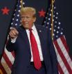 Former President Donald Trump greets supporters as he arrives at a commit to caucus rally, Tuesday, Dec. 19, 2023, in Waterloo, Iowa. (AP Photo/Charlie Neibergall)