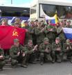 In this photo taken from a video released by Russian Defense Ministry press service, Russian servicemen applaud posing for a photo after returning from captivity following an exchange between Russia and Ukraine, at an undisclosed location in Belarus, Friday, May 23, 2025. (Russian Defense Ministry Press Service via AP)