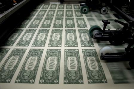 50 subject one dollar note sheets are run through an intaglio printing press before the face is printed at the U.S. Bureau of Engraving and Printing in Washington, D.C., U.S., on Tuesday, April 14, 2015. Republican efforts to pass a fiscal year 2016 budget cleared another hurdle as the House named its members to a conference committee and Senate Majority Leader Mitch McConnell pledged to do the same by the end of the week. Photographer: Andrew Harrer/Bloomberg