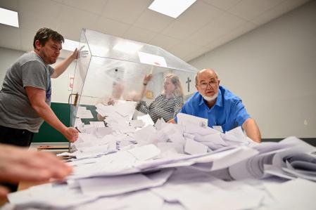 Poll workers open the ballot boxes at a primary school before they are counted during the second round of the presidential elections in Gdansk, on June 1, 2025. Poles voted in a tight presidential election runoff that will have major implications for the country's role in Europe, and for abortion and LGBTQ rights. Opinion polls have predicted an extremely close race with nationalist historian Karol Nawrocki and pro-EU Warsaw Mayor Rafal Trzaskowski neck and neck ahead of the vote.