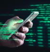 Darkweb, darknet and hacking concept. Hacker with cellphone. Man using dark web with smartphone. Mobile phone fraud, online scam and cyber security threat. Scammer using stolen cell. AR data code.