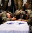 Israeli soldiers mourn over the coffin of army captain Reei Biran, reportedly killed in combat in the southern Gaza Strip the previous day, during his funeral in the northern Israeli Moshav of Nahalal on July 11, 2025. Israeli Prime Minister Benjamin Netanyahu said on July 10 that Israel was ready to start talks for a lasting deal with Hamas when a temporary ceasefire is in place. (Photo by Jalaa MAREY / AFP)