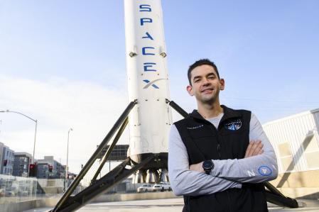 (FILES) Inspiration4 mission commander Jared Isaacman, founder and chief executive officer of Shift4 Payments, stands for a portrait in front of the recovered first stage of a Falcon 9 rocket at Space Exploration Technologies Corp. (SpaceX) on February 2, 2021 in Hawthorne, California. US President-elect Donald Trump on December 4, 2024 nominated Jared Isaacman, the online payments billionaire and the first private astronaut to ever perform a spacewalk, as the next head of NASA. (Photo by Patrick T. FALLON / AFP)