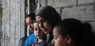 GAZA, Aug. 19, 2025 -- Palestinian woman Reham Said is seen with her children at a temporary shelter in Gaza City, on Aug. 13, 2025. TO GO WITH