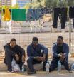 PALMA , 13/08/2025.- Unos migrantes, recién llegados a Baleares , esperan en la estación Marítima de Palma para viajar mañana a la Península. Agentes del servicio marítimo de la Guardia Civil y Salvamento Marítimo han interceptado esta mañana a dos grupos con un total de 43 inmigrantes llegados en dos pateras distintas a Cabrera, con lo que ascienden a 237 las personas arribadas a Baleares este miércoles en quince embarcaciones. EFE/CATI CLADERA
