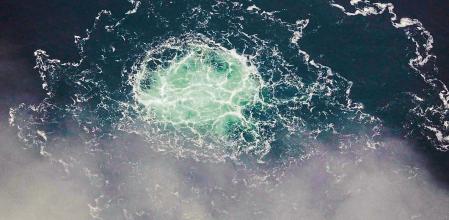 This handout photo taken on September 28, 2022 from an aircraft of the Swedish Coast Guard (Kustbevakningen) shows the release of gas emanating from a leak on the Nord Stream 2 gas pipeline, in the Swedish economic zone in the Baltic Sea. - A fourth leak has been detected in undersea gas pipelines linking Russia to Europe, the Swedish Coast Guard said on September 29, 2022, after explosions were reported earlier this week in suspected sabotage. (Photo by Handout / SWEDISH COAST GUARD / AFP) / RESTRICTED TO EDITORIAL USE - MANDATORY CREDIT