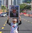 A child holds a sign during a demonstration against U.S. President Donald Trump's attendance at the Association of Southeast Asian Nations (ASEAN) Summit in Kuala Lumpur, Malaysia, on Sunday, Oct. 26, 2025. (AP Photo/Azneal Ishak)