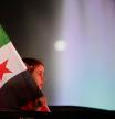 A girl holds a Syrian flag during celebrations of the first anniversary of the ousting of the Bashar Assad regime in Damascus, Syria, early Saturday, Dec. 6, 2025. (AP Photo/Omar Sanadiki)