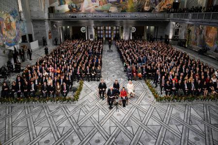 General view shows Norway's royal family, (first row) Norway's King Harald and Queen Sonja, (2nd row L-R) Crown Prince Haakon, Princess Ingrid Alexandra and Crown Princess Mette-Marit and guests attending the awarding ceremony of the 2024 Nobel Peace Prize at the City Hall in Oslo on December 10, 2025. The 2025 Nobel Peace Prize was awarded to Maria Corina Machado for her efforts to bring democracy to Venezuela, challenging the iron-fisted rule of Venezuelan President Nicolas Maduro, who has been president since 2013. (Photo by Stian Lysberg Solum / NTB / AFP) / Norway OUT